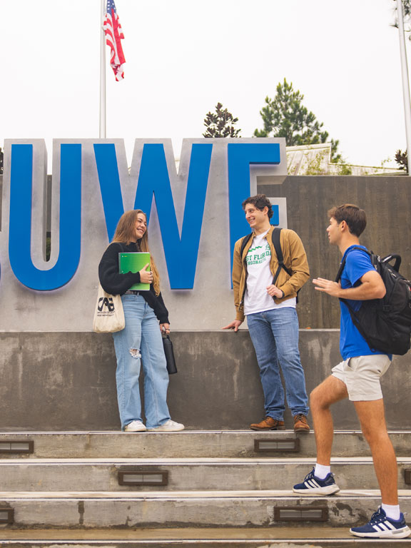 Students standing at the UWF entrance plaza