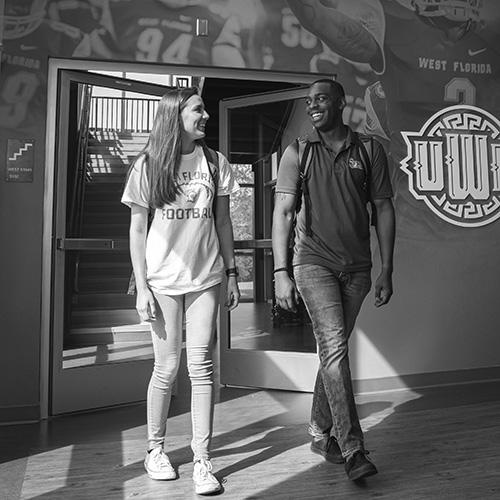two students walking inside the darrell gooden building